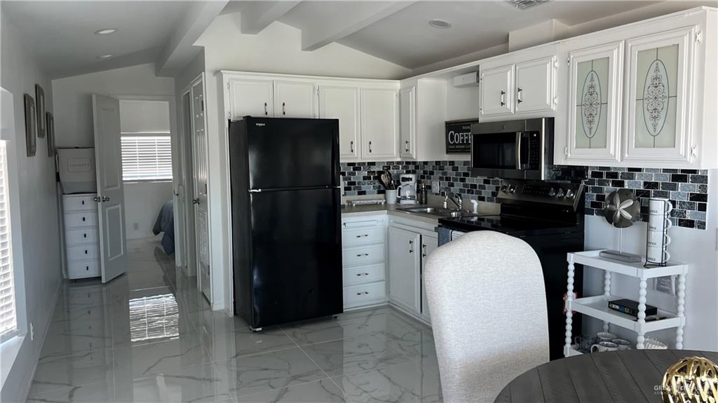 318 Sun Dial Circle Port Isabel, TX 78578 - Photo 3 of 19 a kitchen with stainless steel appliances a refrigerator a stove a microwave and a refrigerator