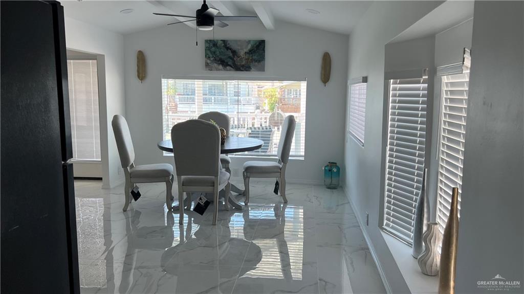 318 Sun Dial Circle Port Isabel, TX 78578 - Photo 8 of 19 a view of a dining room with furniture and a large window