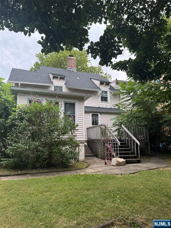103 Sylvan Street Rutherford, NJ 07070 - Photo 2 of 8 a view of a house with pool and a bench
