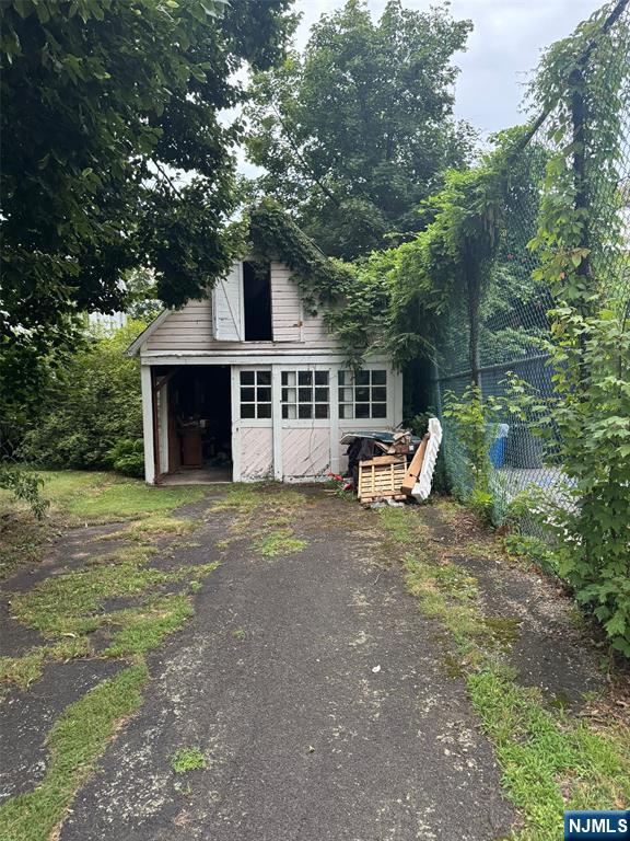 103 Sylvan Street Rutherford, NJ 07070 - Photo 4 of 8 a front view of a house with a yard and trees
