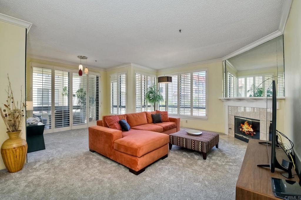 5865 Friars Road, Unit 3202 San Diego, CA 92110 - Photo 1 of 1 a living room with furniture and a fireplace