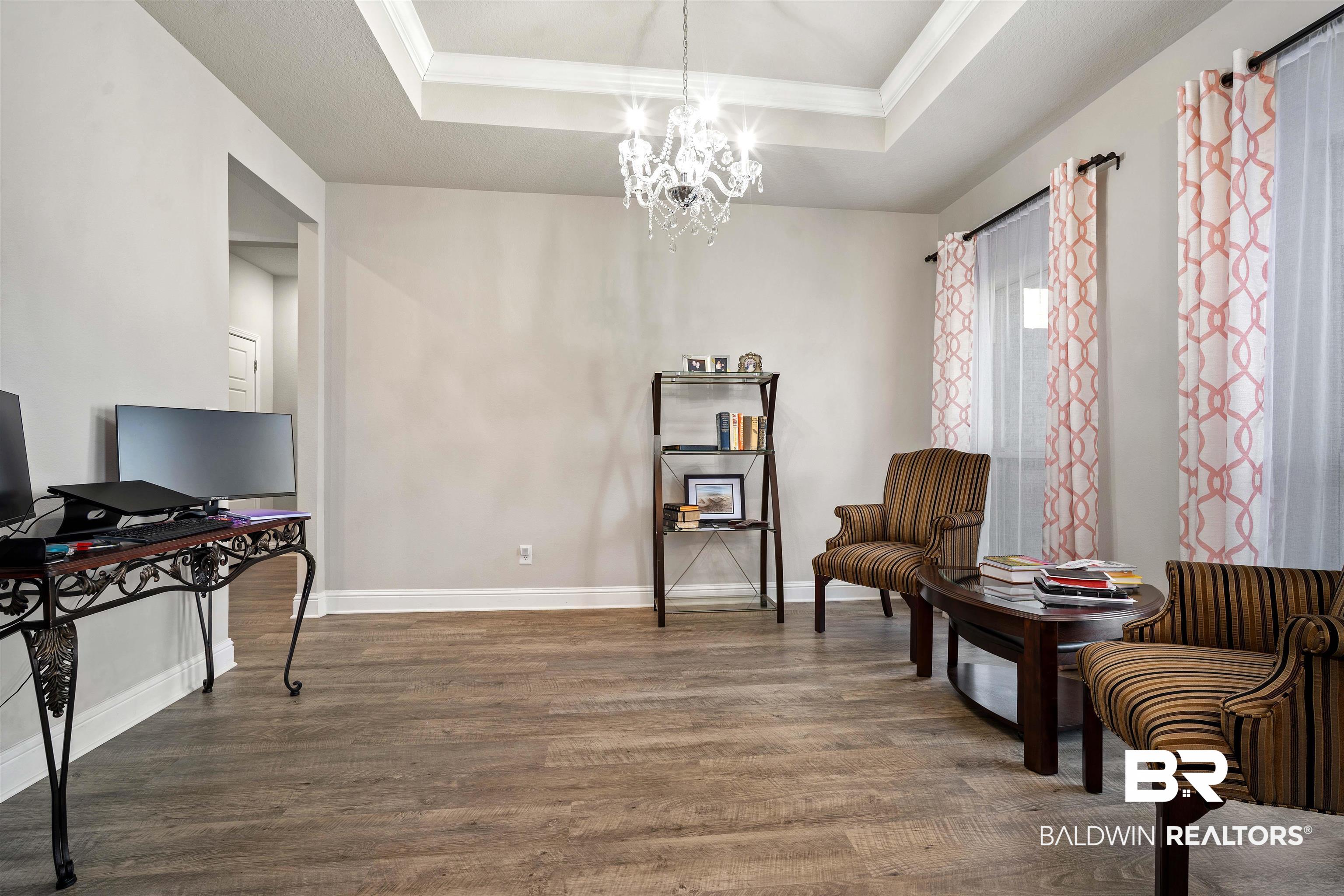 1700 Gwin Court Mobile, AL 36695 - Photo 11 of 36 Sitting room featuring crown molding, a chandelier, and a raised ceiling