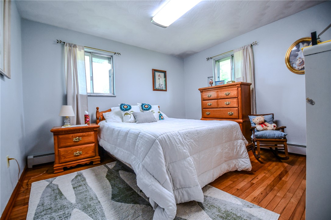 10833 Kendig Road Medway, OH 45341 - Photo 27 of 46 This cozy bedroom features polished hardwood flooring and natural light through elegant windows.