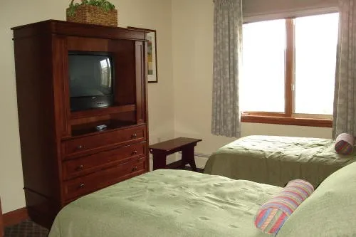 a bedroom with a bed and a mirror on dresser