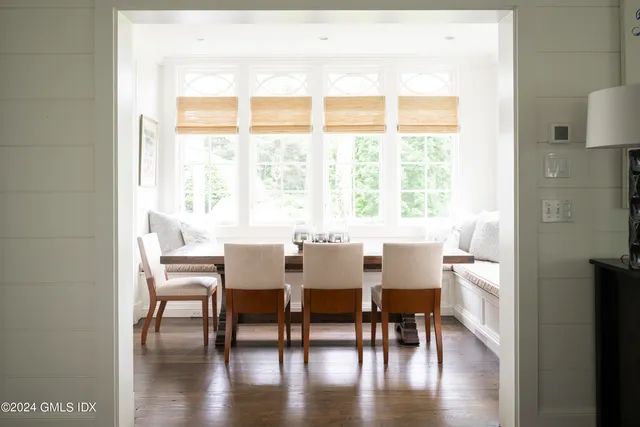 a view of a dining room with furniture and wooden floor