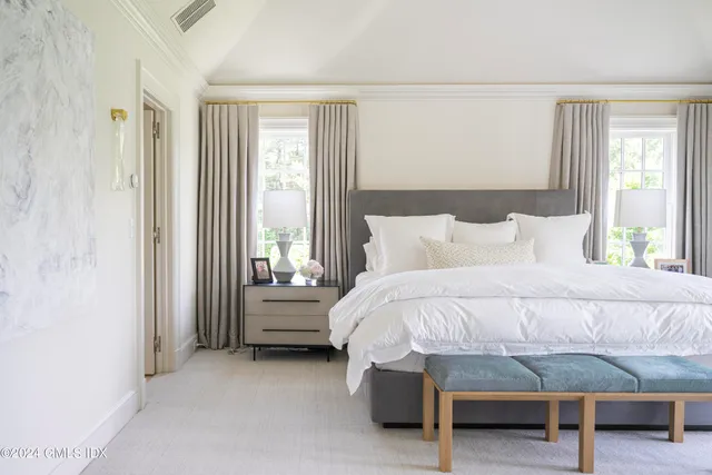 a bedroom with a bed and a table