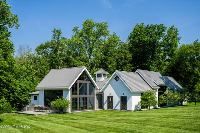 a aerial view of a house with a big yard potted plants and large tree