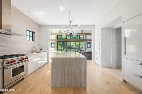 a kitchen with stove and white cabinets