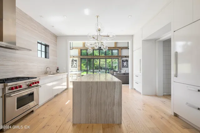 a kitchen with stove and white cabinets