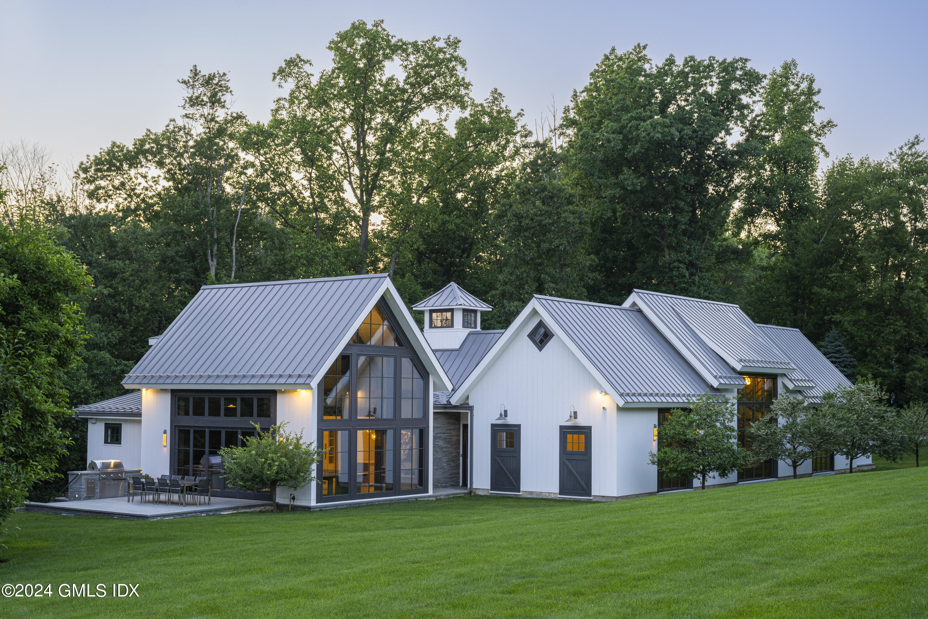865 Hollow Tree Ridge Road Darien, CT 06820 - Photo 34 of 37 a front view of a house with a garden and porch