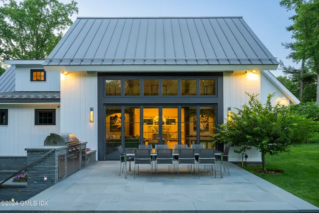 a view of house with a chairs and table in patio