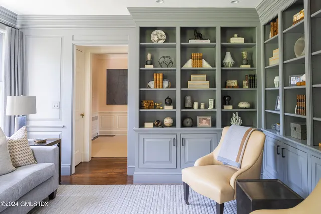 a living room with furniture cabinets and a book shelf