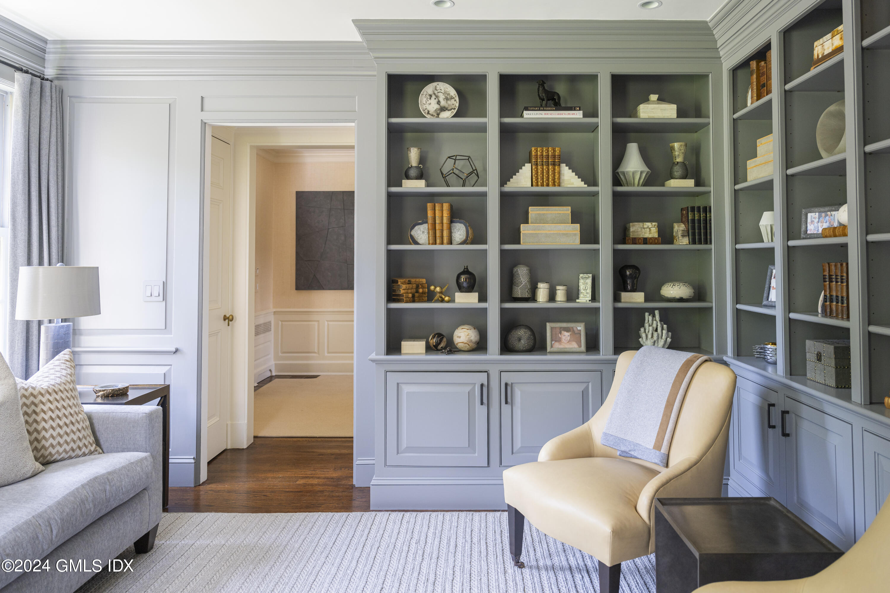 865 Hollow Tree Ridge Road Darien, CT 06820 - Photo 7 of 37 a living room with furniture cabinets and a book shelf