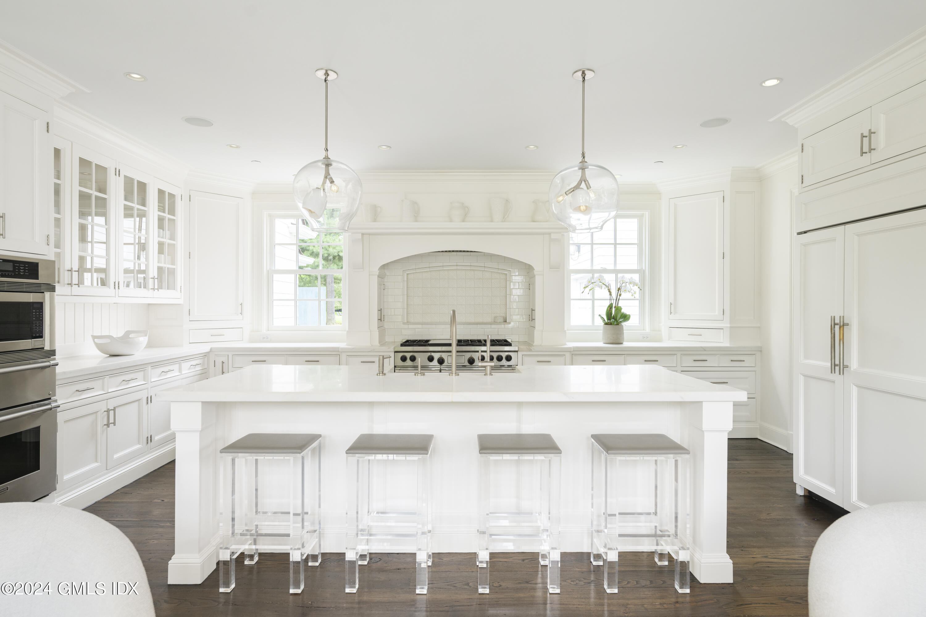 865 Hollow Tree Ridge Road Darien, CT 06820 - Photo 10 of 37 a kitchen with a stove a sink a dining table and chairs