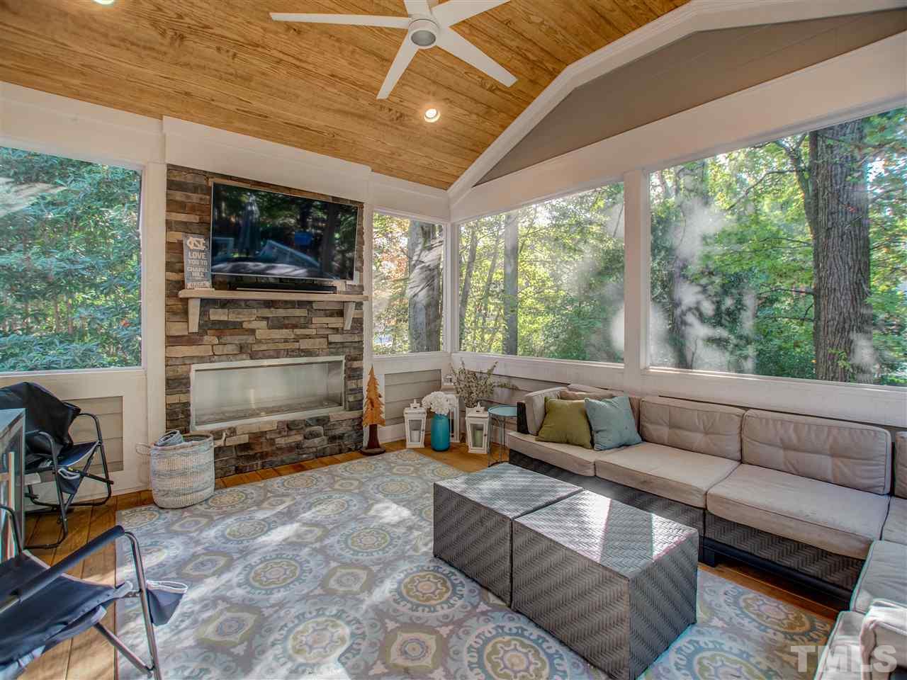 4307 Oakthorne Way Raleigh, NC 27613 - Photo 15 of 30 a living room with furniture a flat screen tv and a fireplace
