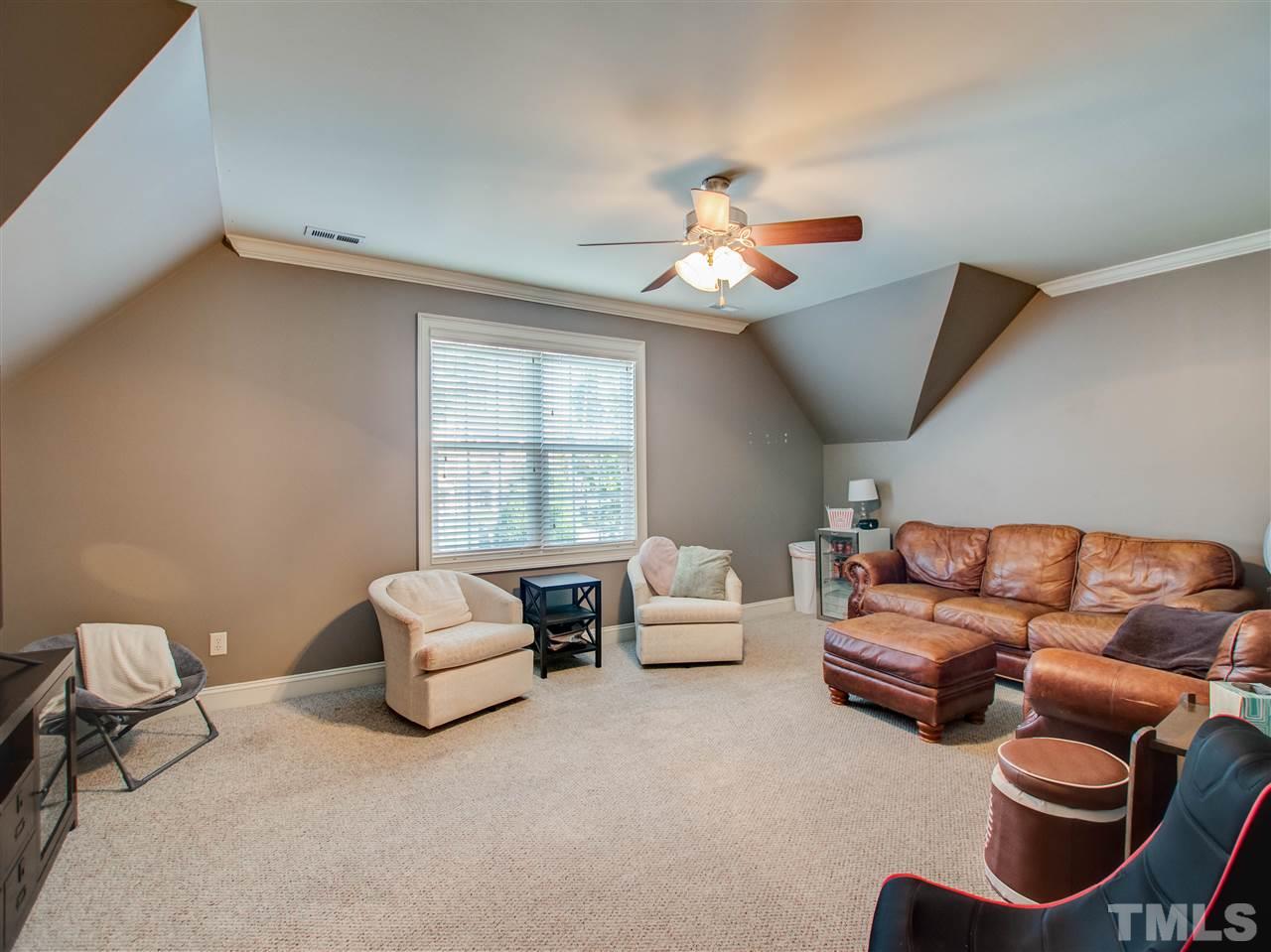 4307 Oakthorne Way Raleigh, NC 27613 - Photo 26 of 30 a living room with furniture ceiling fan and a window