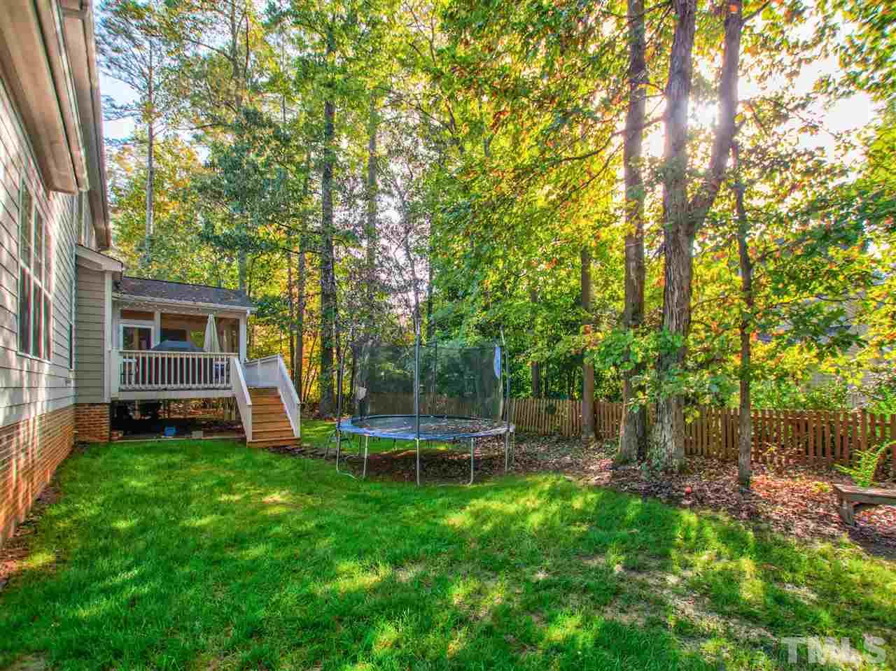 4307 Oakthorne Way Raleigh, NC 27613 - Photo 27 of 30 a view of a backyard with table and chairs and a large tree