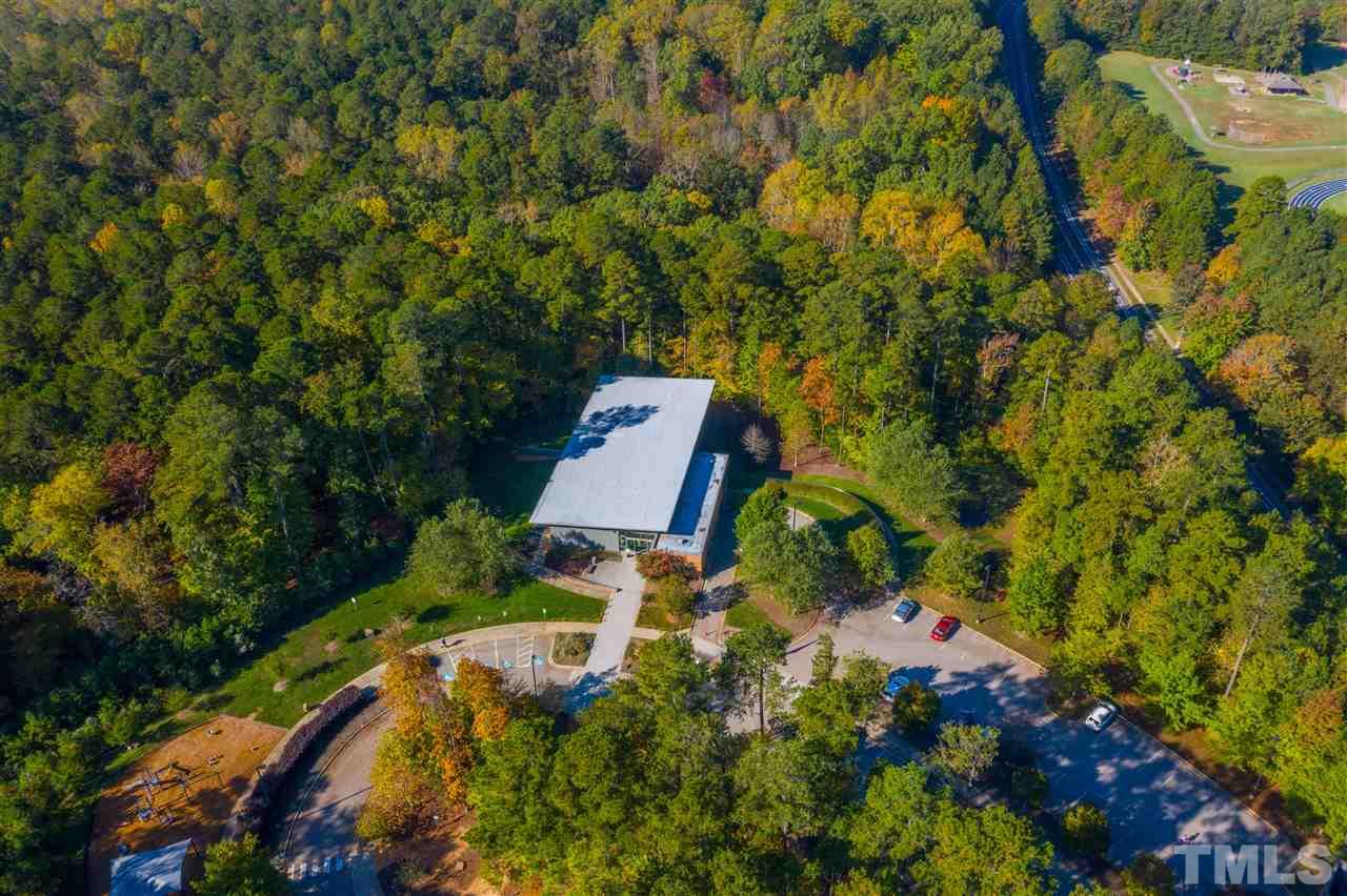 4307 Oakthorne Way Raleigh, NC 27613 - Photo 29 of 30 a backyard of a house with lots of green space and garden
