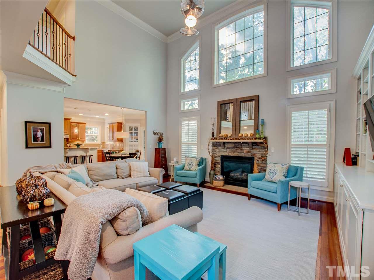 4307 Oakthorne Way Raleigh, NC 27613 - Photo 7 of 30 a living room with furniture a fireplace and a window