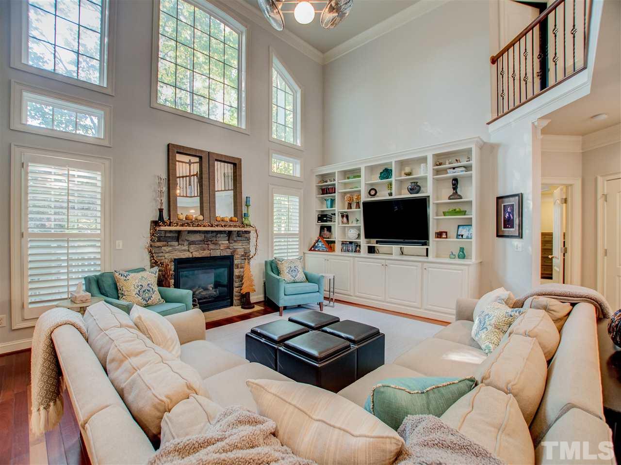 4307 Oakthorne Way Raleigh, NC 27613 - Photo 10 of 30 a living room with furniture a flat screen tv and a fireplace