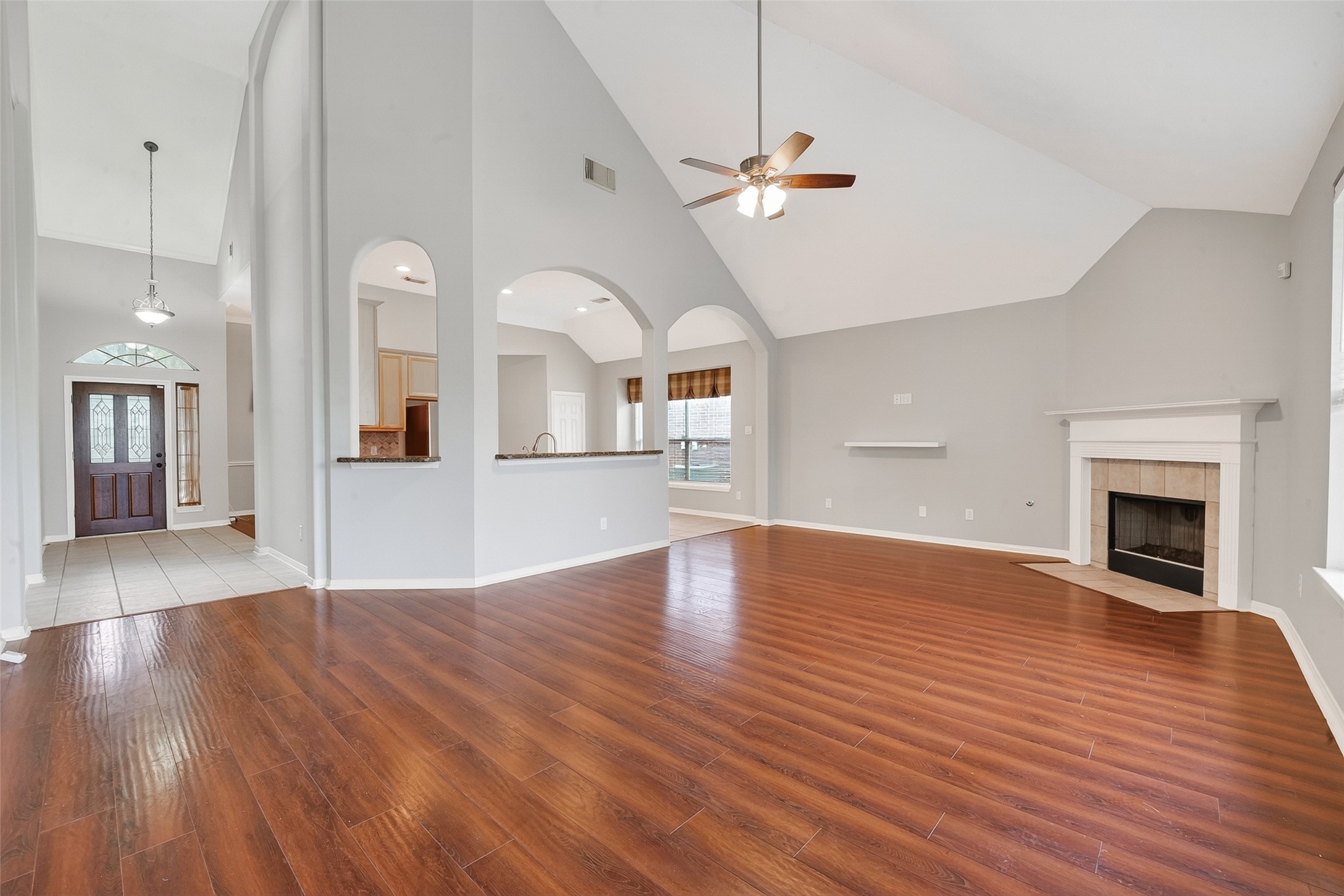 14308 Rocky Briar Lane Rosharon, TX 77583 - Photo 19 of 46 a view of empty room with wooden floor and fireplace