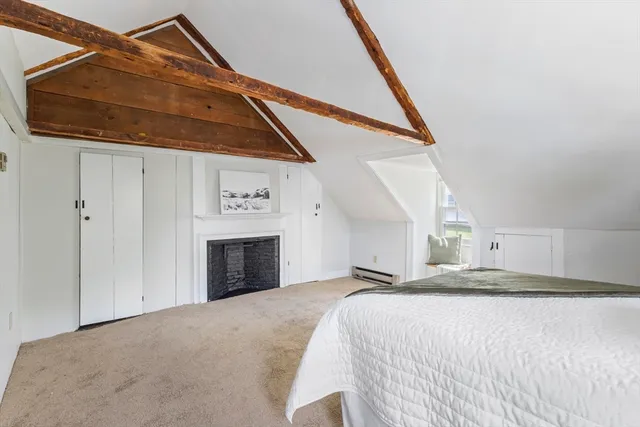 a bedroom with a bed and a fireplace