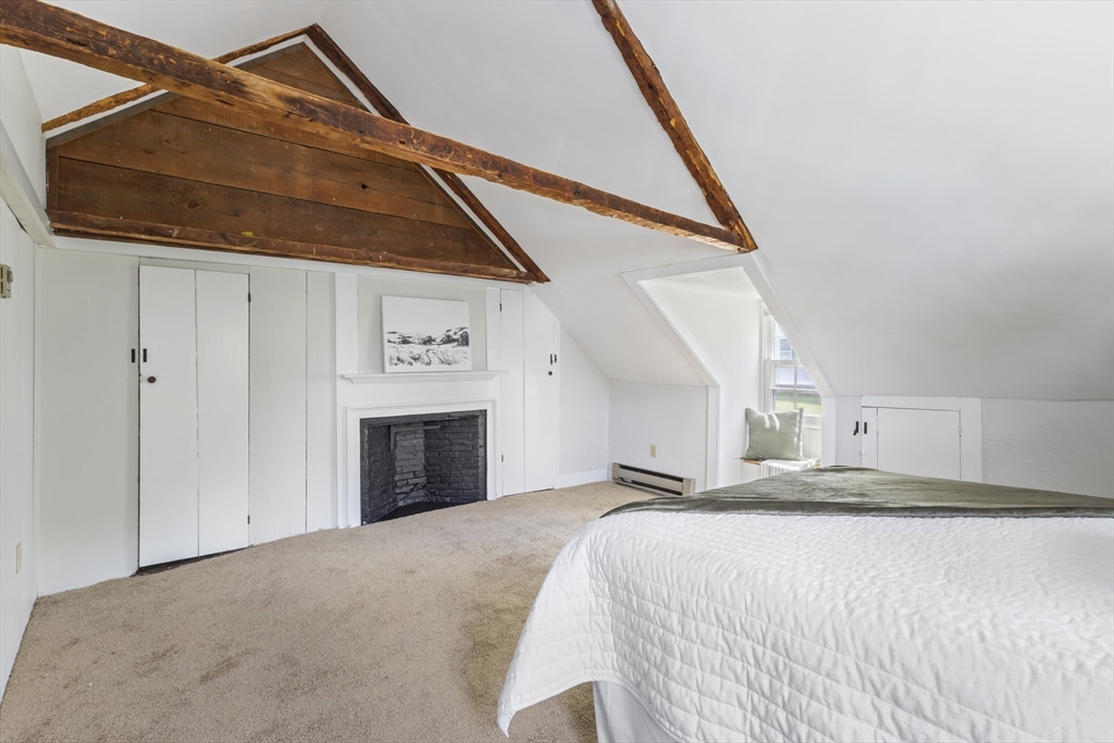 191-193 South Street, Unit 1 Hingham, MA 02043 - Photo 12 of 23 a bedroom with a bed and a fireplace