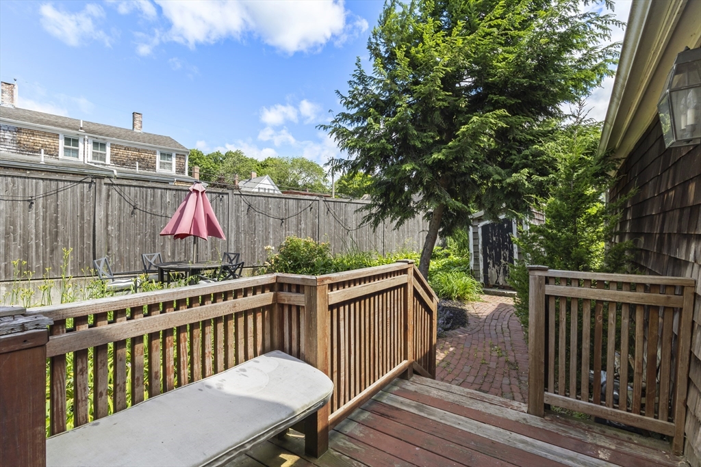 191-193 South Street, Unit 1 Hingham, MA 02043 - Photo 16 of 23 a view of a wooden deck and a backyard