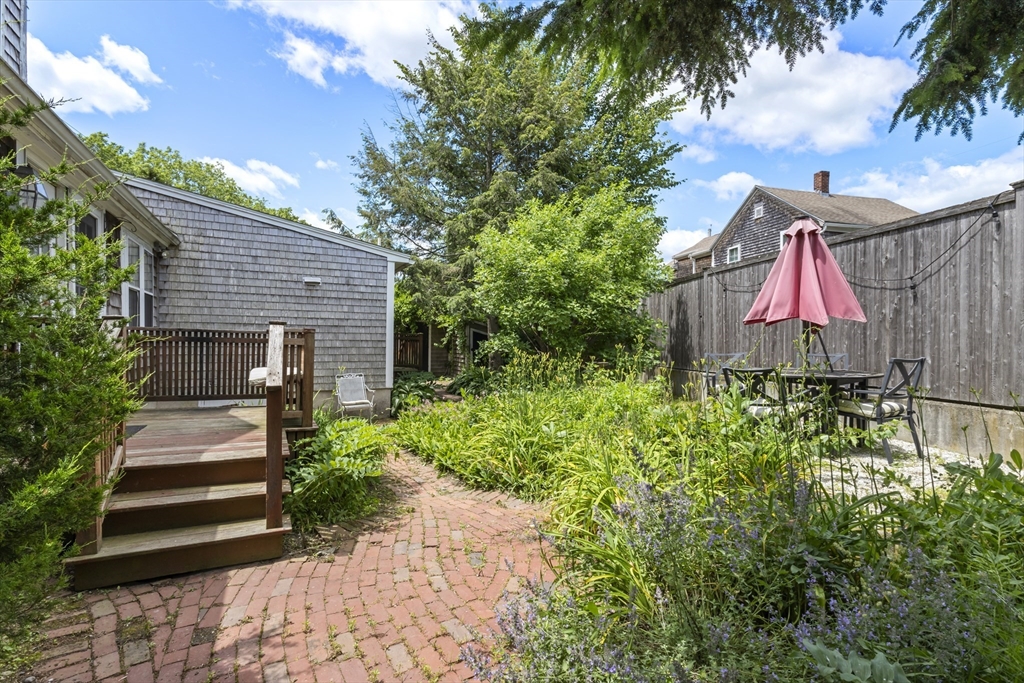 191-193 South Street, Unit 1 Hingham, MA 02043 - Photo 18 of 23 a front view of a house with a yard and potted plants