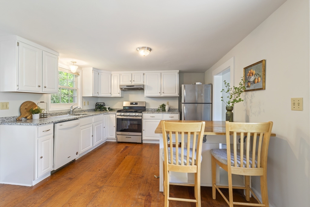 191-193 South Street, Unit 1 Hingham, MA 02043 - Photo 2 of 23 a kitchen with stainless steel appliances granite countertop a sink and cabinets