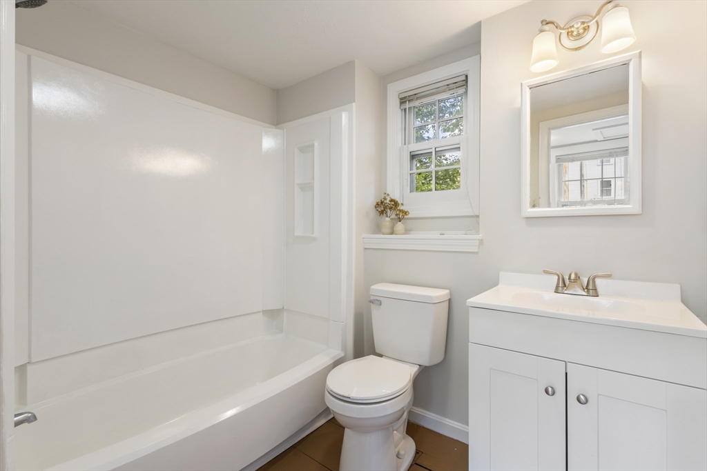 191-193 South Street, Unit 1 Hingham, MA 02043 - Photo 9 of 23 a bathroom with a sink toilet and vanity