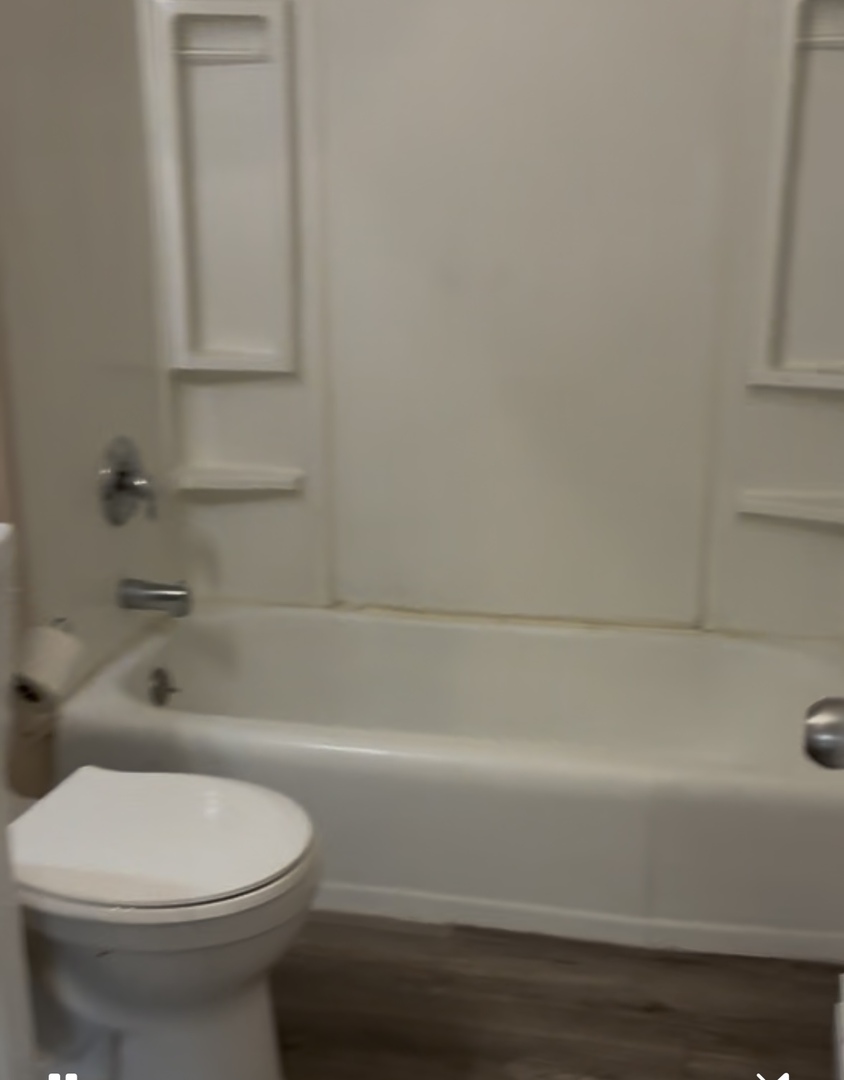 1184 East Merchant Street, Unit 213 Kankakee, IL 60901 - Photo 6 of 6 a bathroom with a toilet and a bathtub