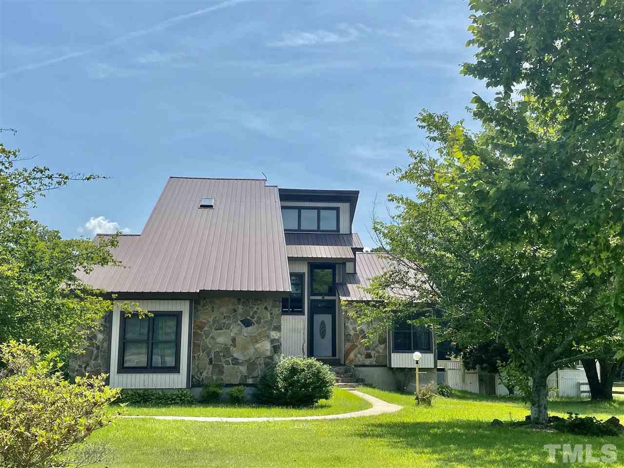 8235 Springhill Church Road Lucama, NC 27851 - Photo 1 of 30 a front view of a house with garden