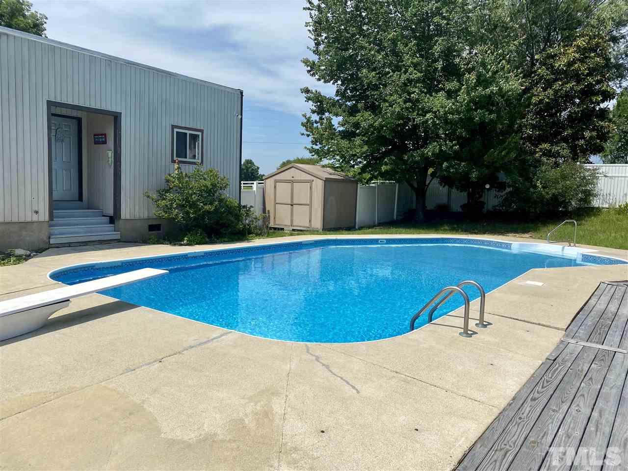 8235 Springhill Church Road Lucama, NC 27851 - Photo 11 of 30 a view of a swimming pool with an outdoor seating