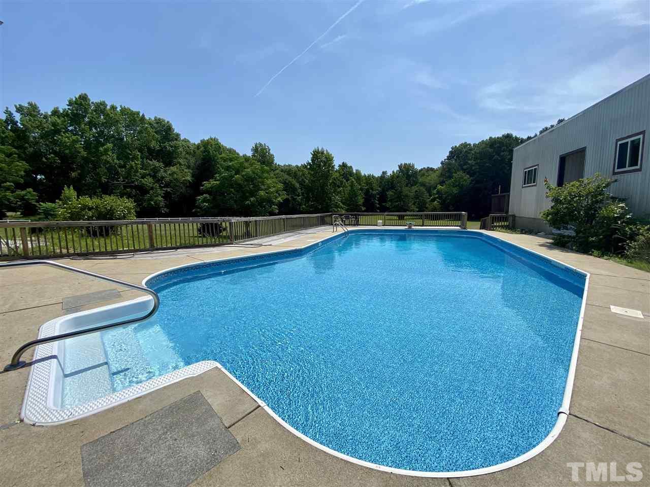 8235 Springhill Church Road Lucama, NC 27851 - Photo 12 of 30 a view of a swimming pool with lake from inside of house