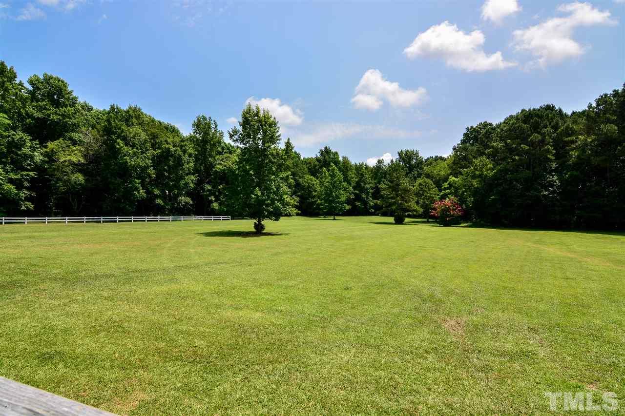 8235 Springhill Church Road Lucama, NC 27851 - Photo 14 of 30 a view of a green field with wooden fence