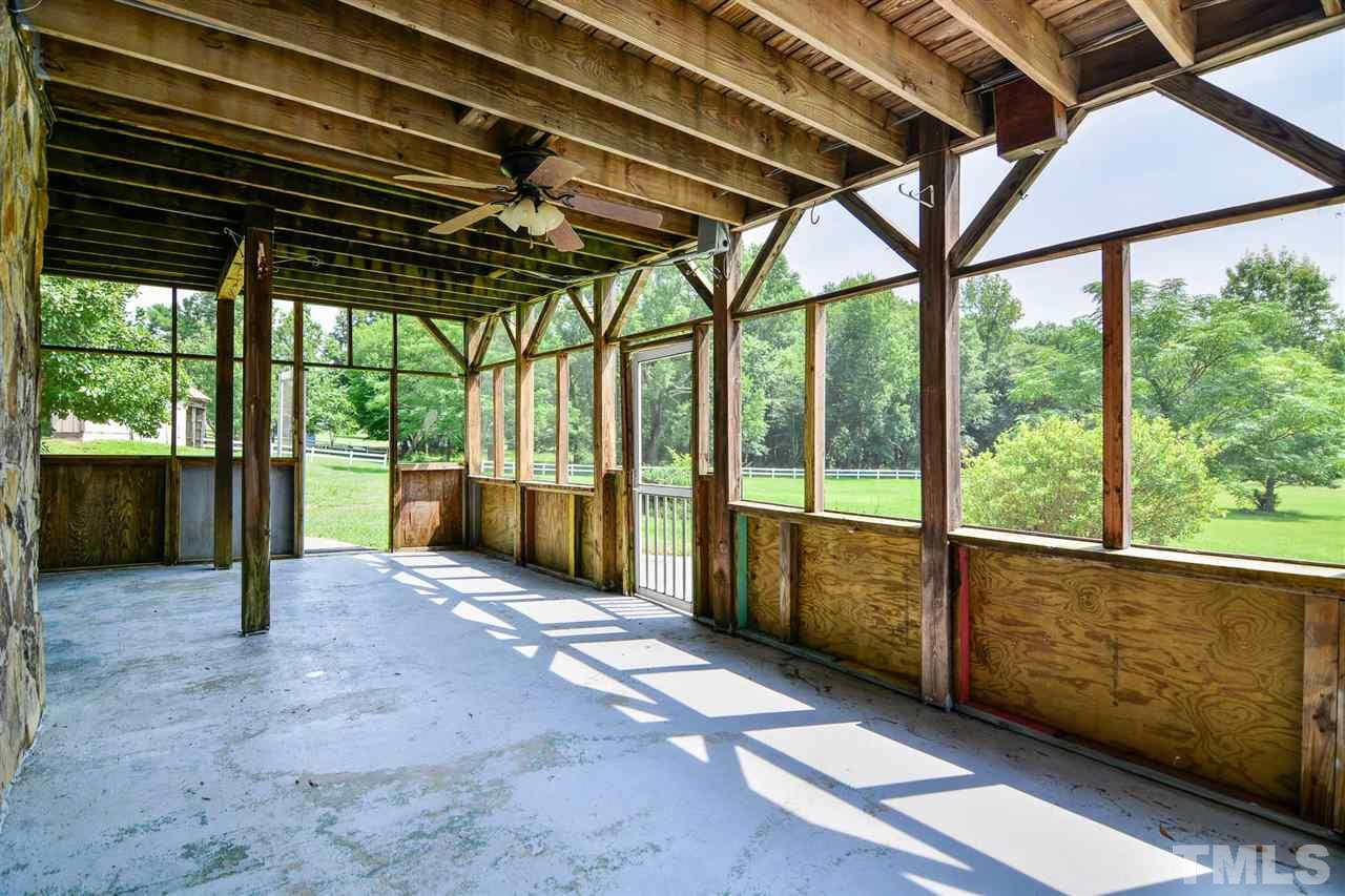 8235 Springhill Church Road Lucama, NC 27851 - Photo 17 of 30 a view of porch with a table under an umbrella