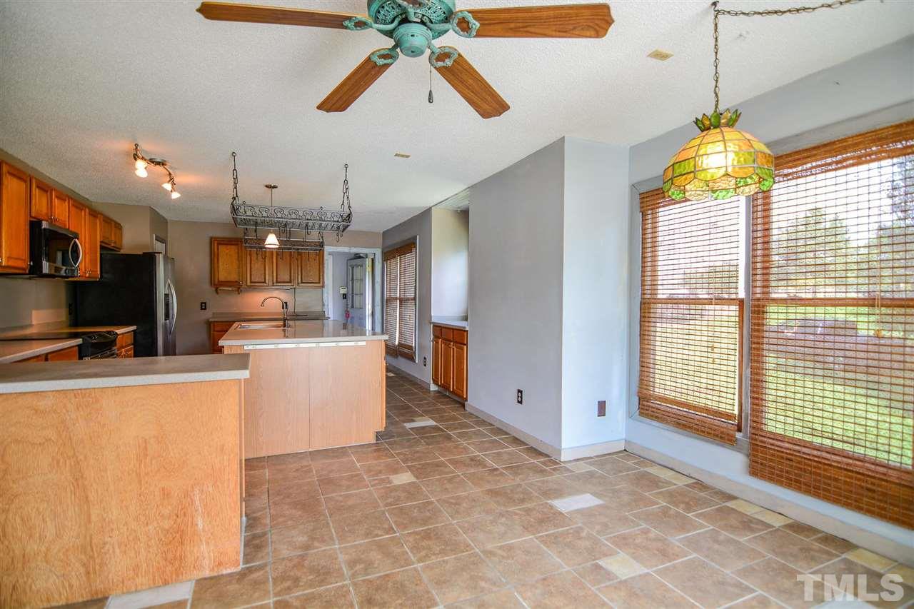 8235 Springhill Church Road Lucama, NC 27851 - Photo 19 of 30 a view of a kitchen with furniture and a flat screen tv
