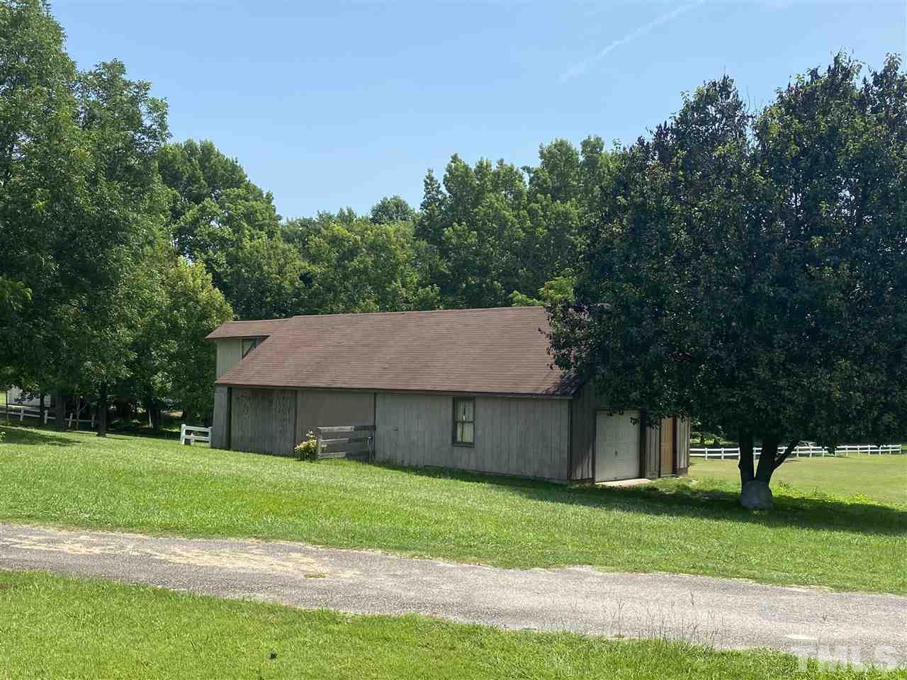 8235 Springhill Church Road Lucama, NC 27851 - Photo 3 of 30 a house with a yard plants and large tree