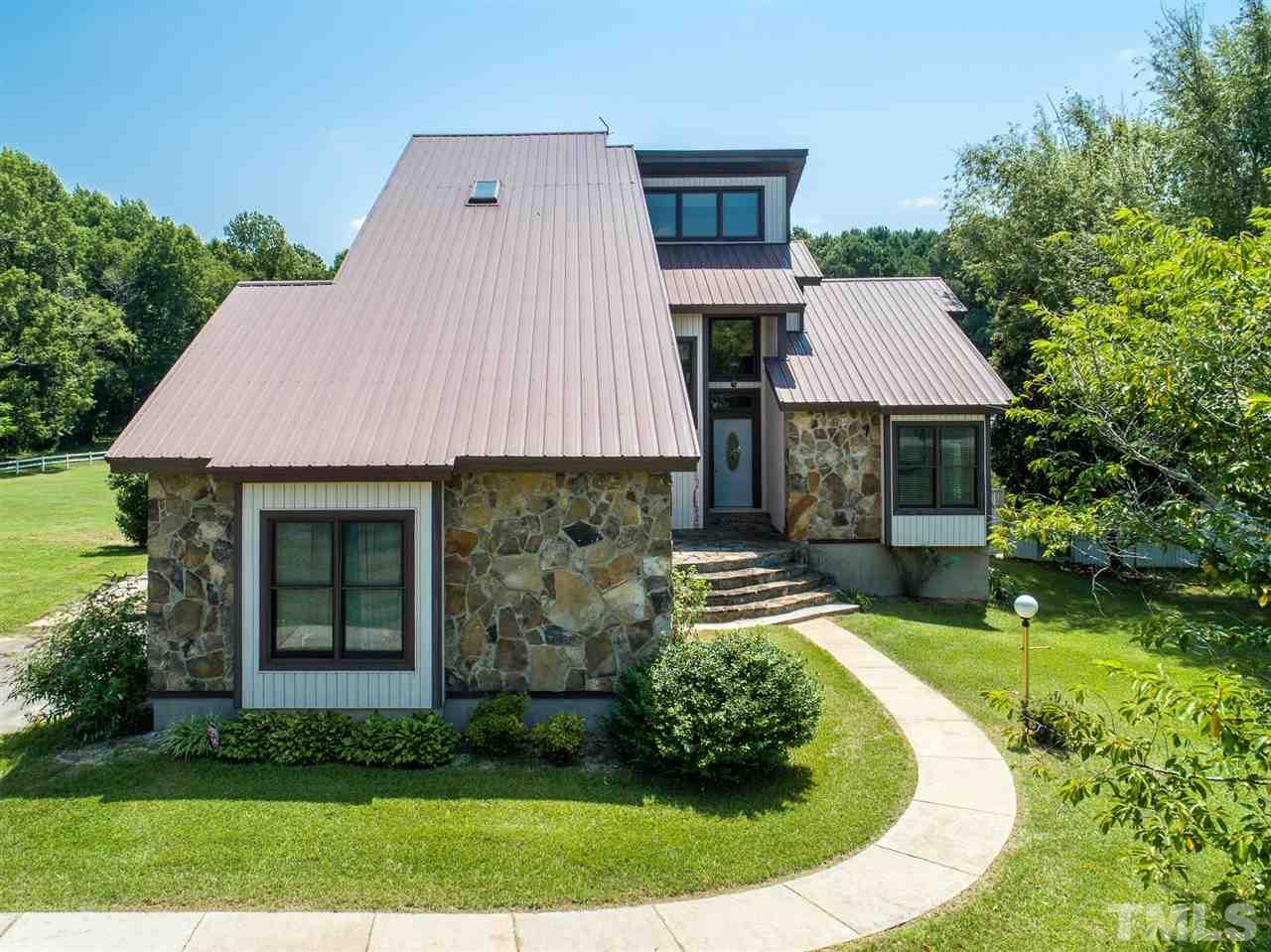 8235 Springhill Church Road Lucama, NC 27851 - Photo 21 of 30 a aerial view of a house with garden and trees