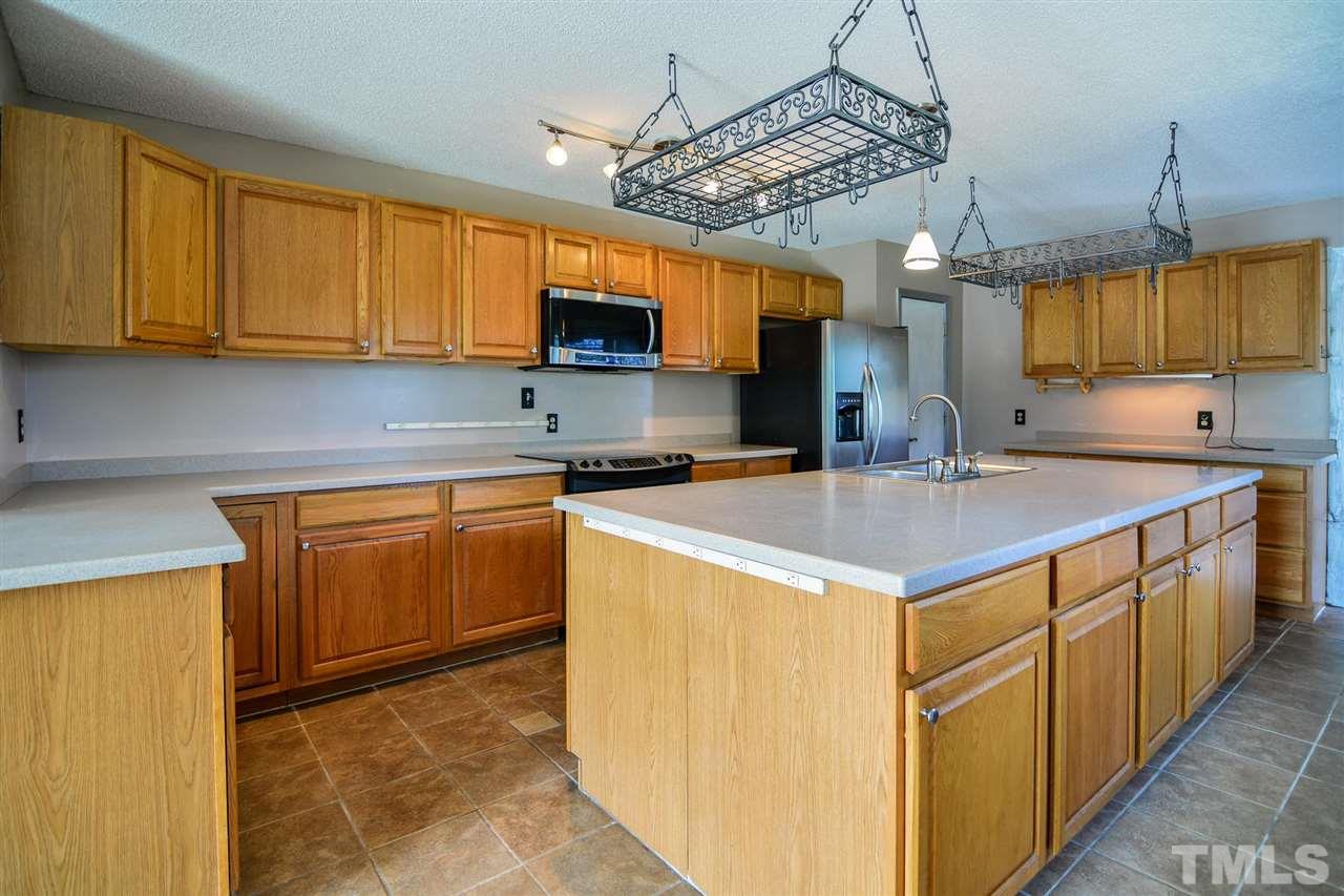 8235 Springhill Church Road Lucama, NC 27851 - Photo 24 of 30 a kitchen with a sink a counter top space cabinets and stainless steel appliances