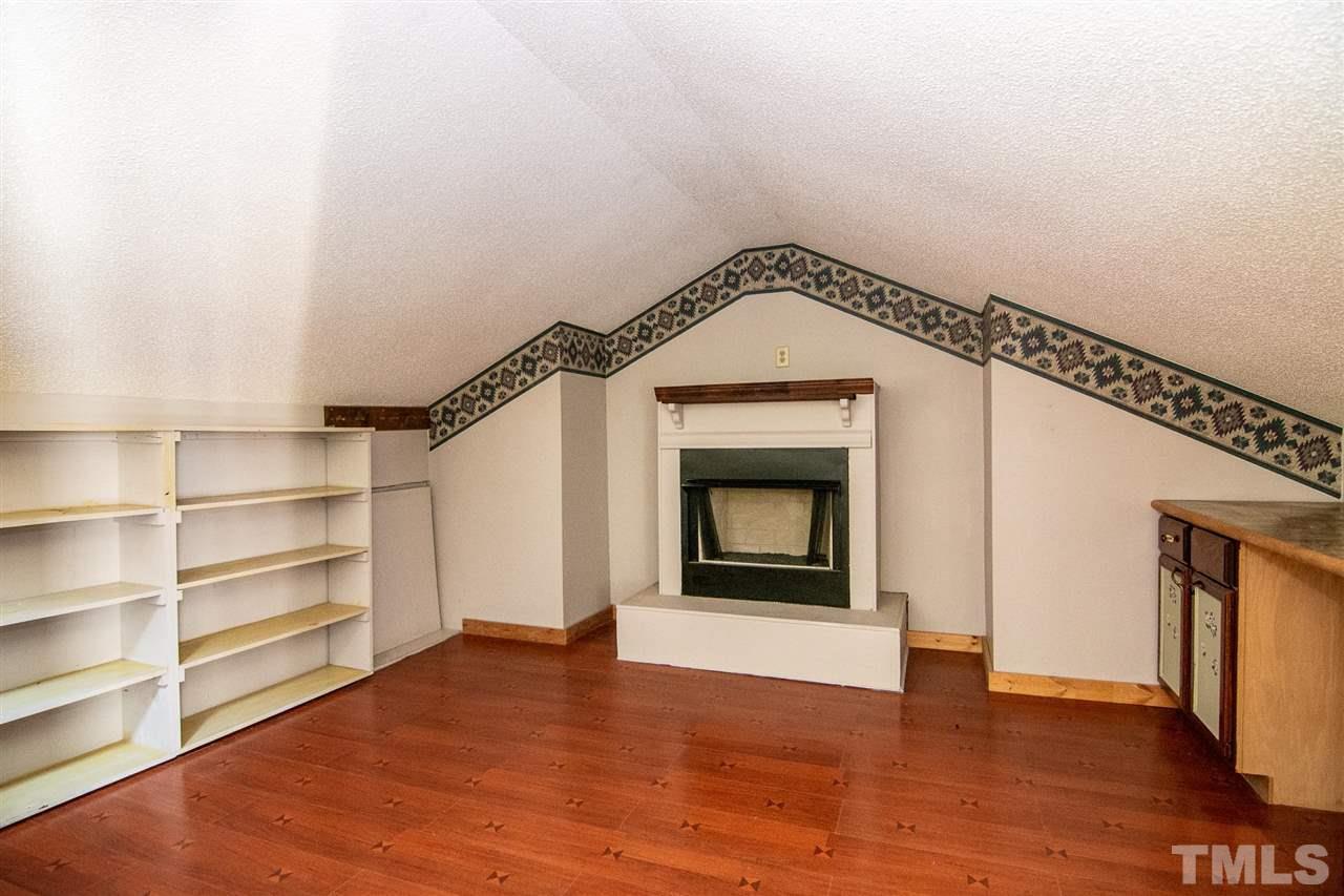 8235 Springhill Church Road Lucama, NC 27851 - Photo 25 of 30 a view of an empty room with a fireplace and a window