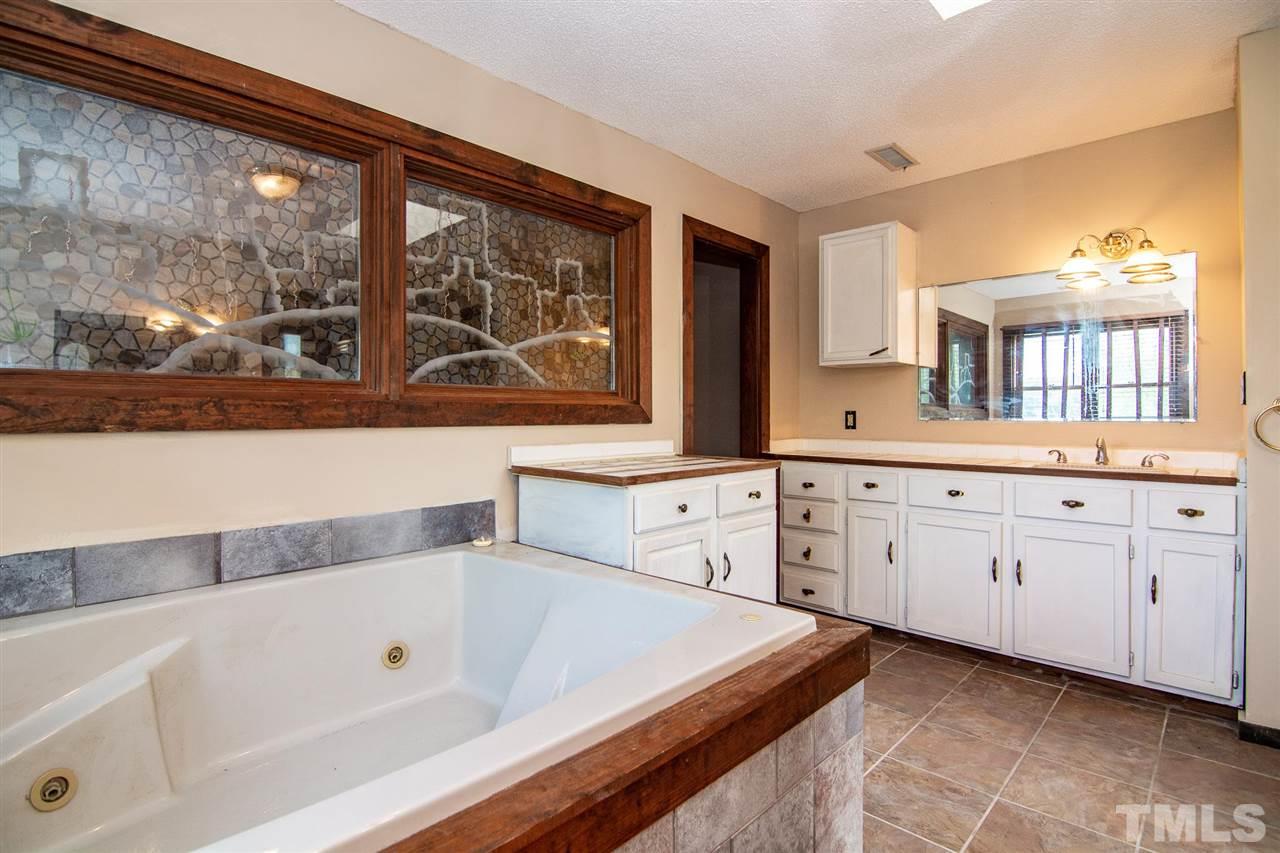 8235 Springhill Church Road Lucama, NC 27851 - Photo 26 of 30 a bathroom with a bathtub sink and large window