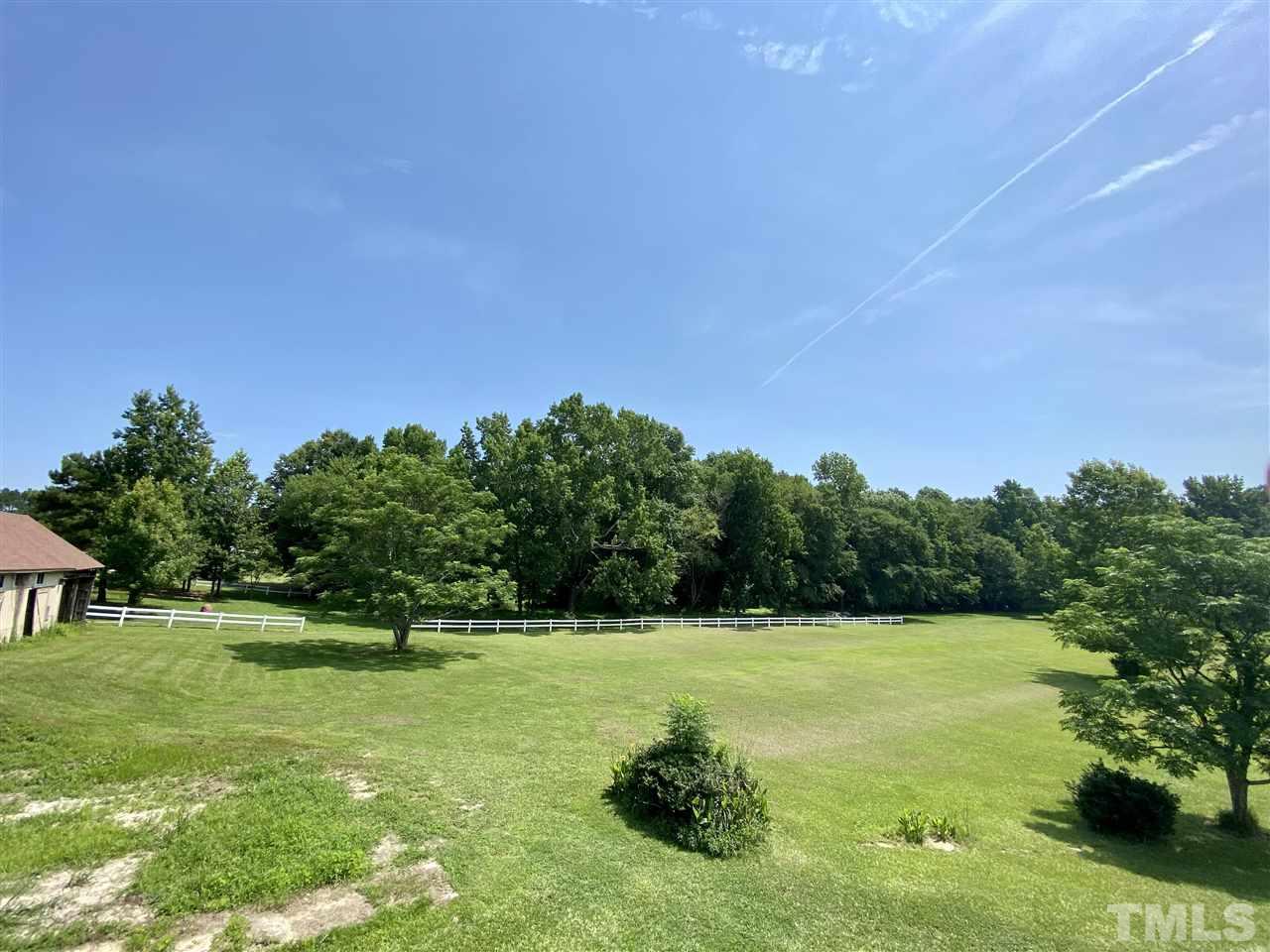 8235 Springhill Church Road Lucama, NC 27851 - Photo 5 of 30 a view of a green field with wooden fence