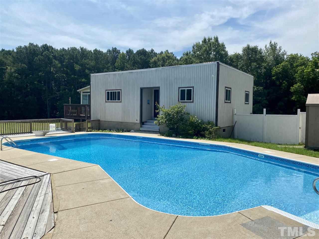 8235 Springhill Church Road Lucama, NC 27851 - Photo 10 of 30 a view of a backyard with potted plants and a large tree