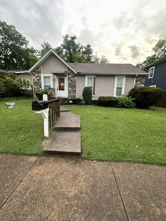 a view of a yard in front view of a house