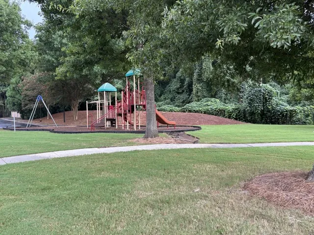 a view of outdoor space with playground and green space