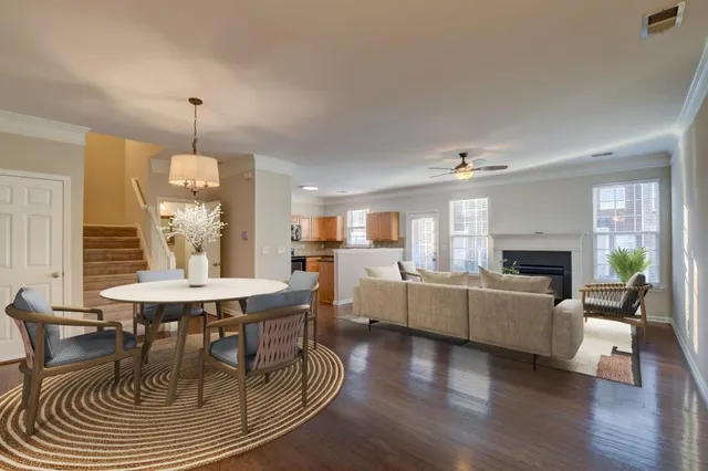 a dining room with furniture a chandelier and wooden floor