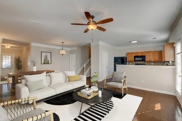 a living room with furniture and kitchen view