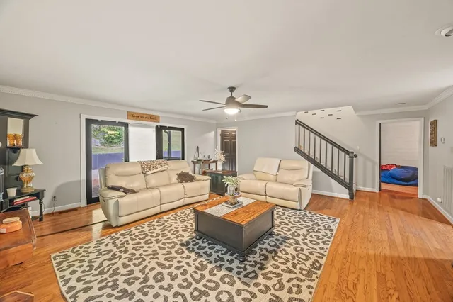 a living room with furniture and wooden floor